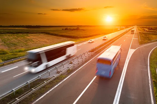 depositphotos_51408571-stock-photo-two-buses-on-highway-in